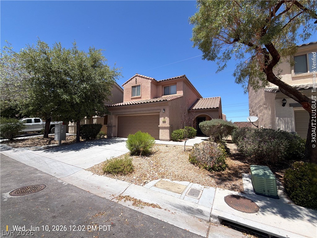2388 Rue Bienville Way Henderson, NV 89044 - Photo 1 of 16 A terracotta-roofed residence presents a blend of stucco and well-maintained desert landscaping.