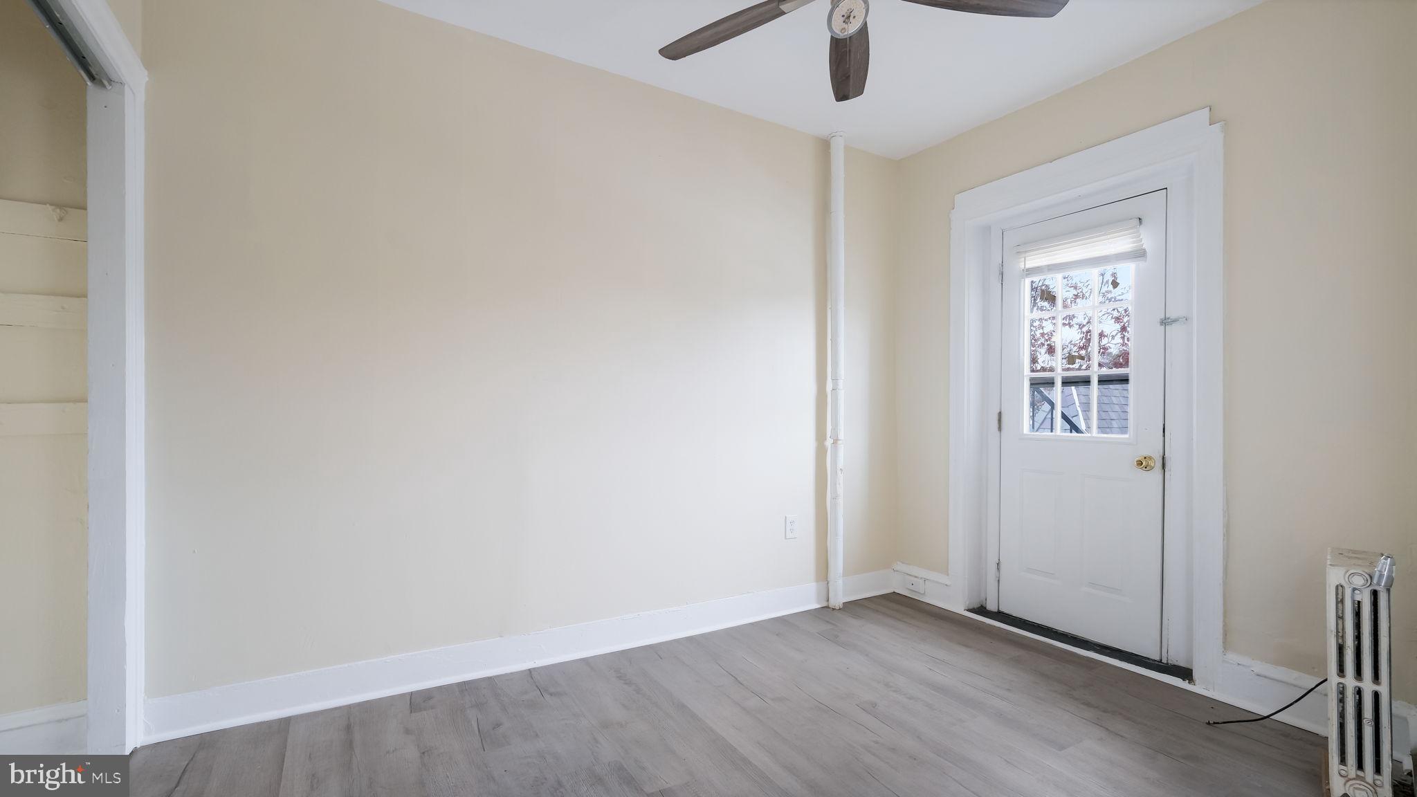 2 West State Street, Unit 2A Media, PA 19063 - Photo 8 of 12 an empty room with a window and a ceiling fan
