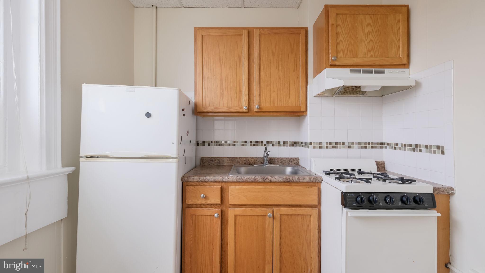 2 West State Street, Unit 2A Media, PA 19063 - Photo 10 of 12 a kitchen with a refrigerator and a sink