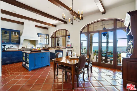 a room with granite countertop furniture a dining table and a large window