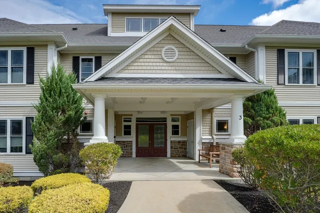 a front view of a house with a garden and patio