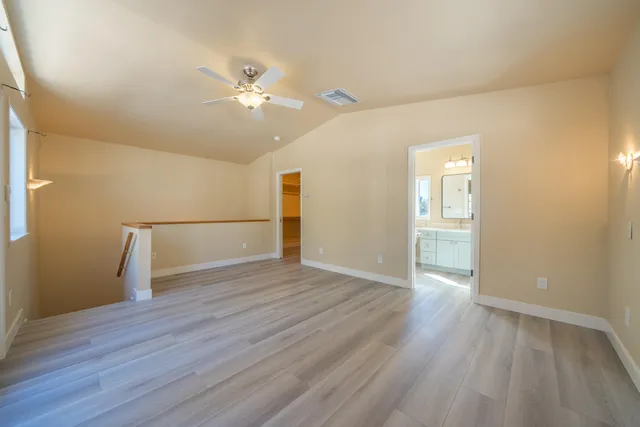 a bedroom with a bed and a painting on the wall
