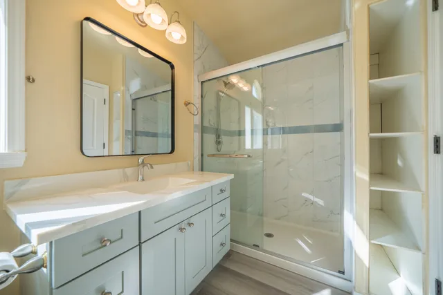 a view of an empty room with wooden floor