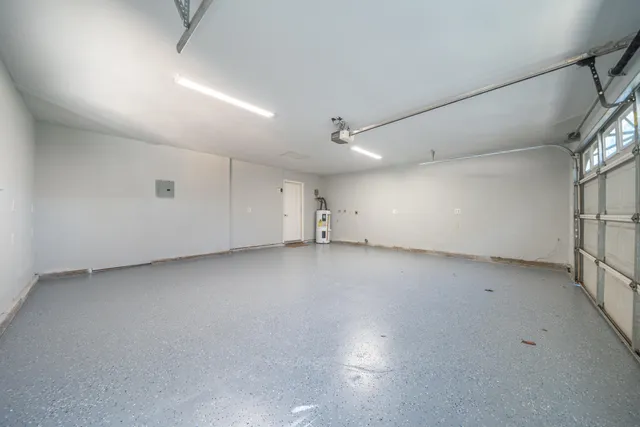 a view of a patio with table and chairs under an umbrella