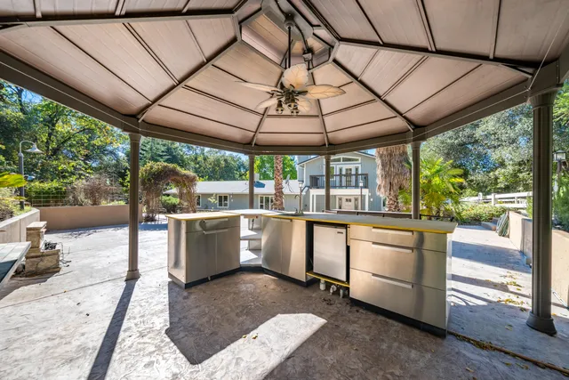 a house view with swimming pool in front of it