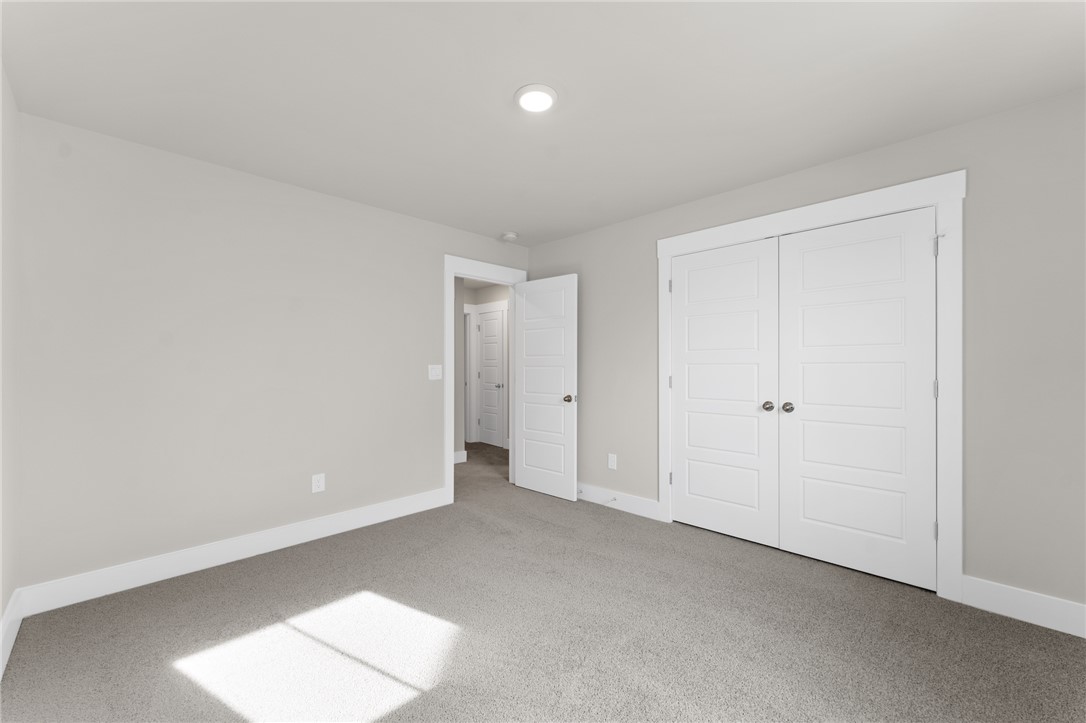 167 Tiger Lily Drive Anderson, SC 29621 - Photo 23 of 34 A well-lit bedroom with fresh, neutral walls and soft carpeting invites restful living.