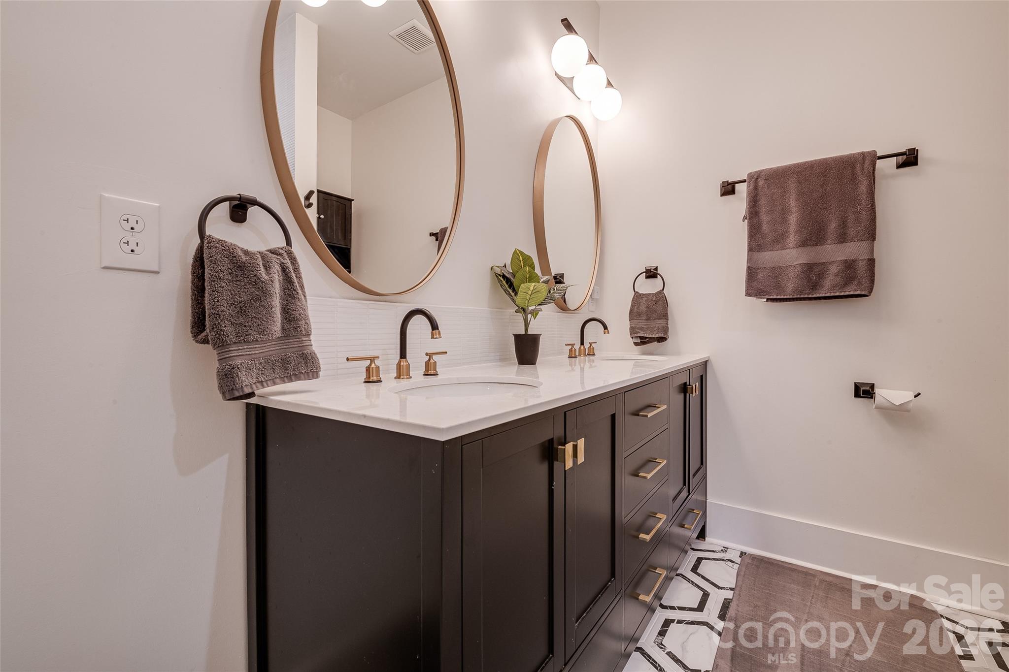 1516 Princess Place Charlotte, NC 28208 - Photo 29 of 46 a bathroom with a double vanity sink and a mirror