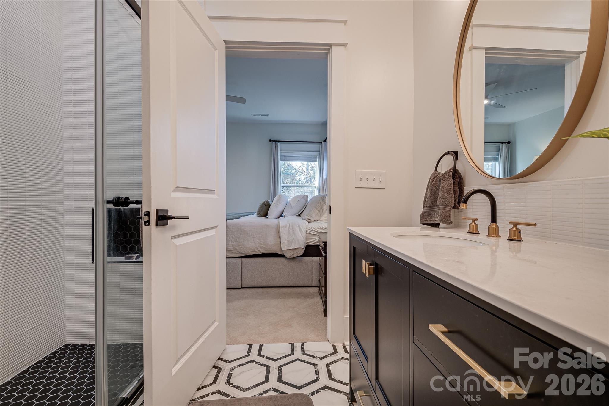 1516 Princess Place Charlotte, NC 28208 - Photo 31 of 46 a en suite bathroom with a sink and a mirror