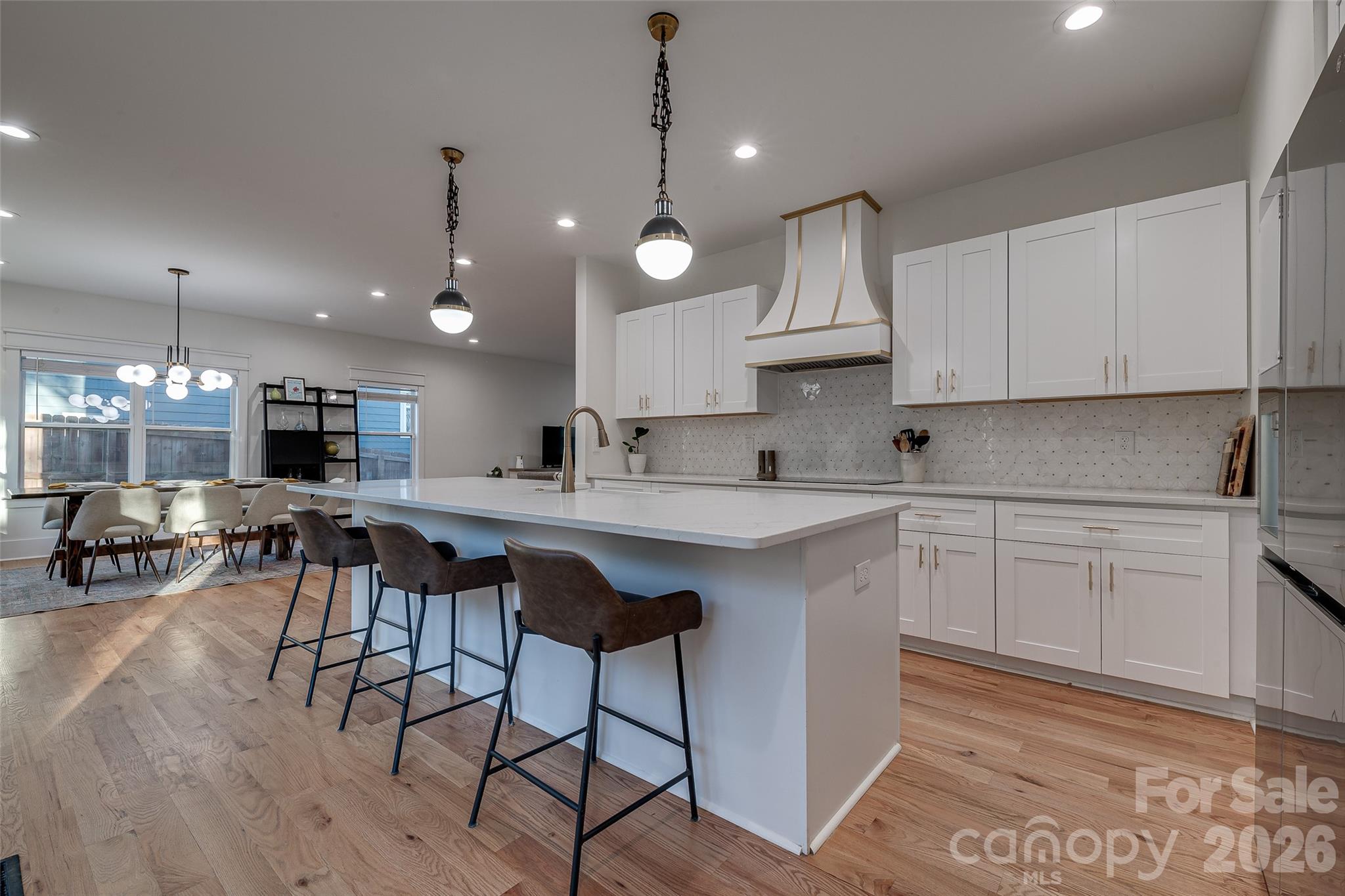 1516 Princess Place Charlotte, NC 28208 - Photo 8 of 46 a kitchen with cabinets a sink stainless steel appliances and chairs