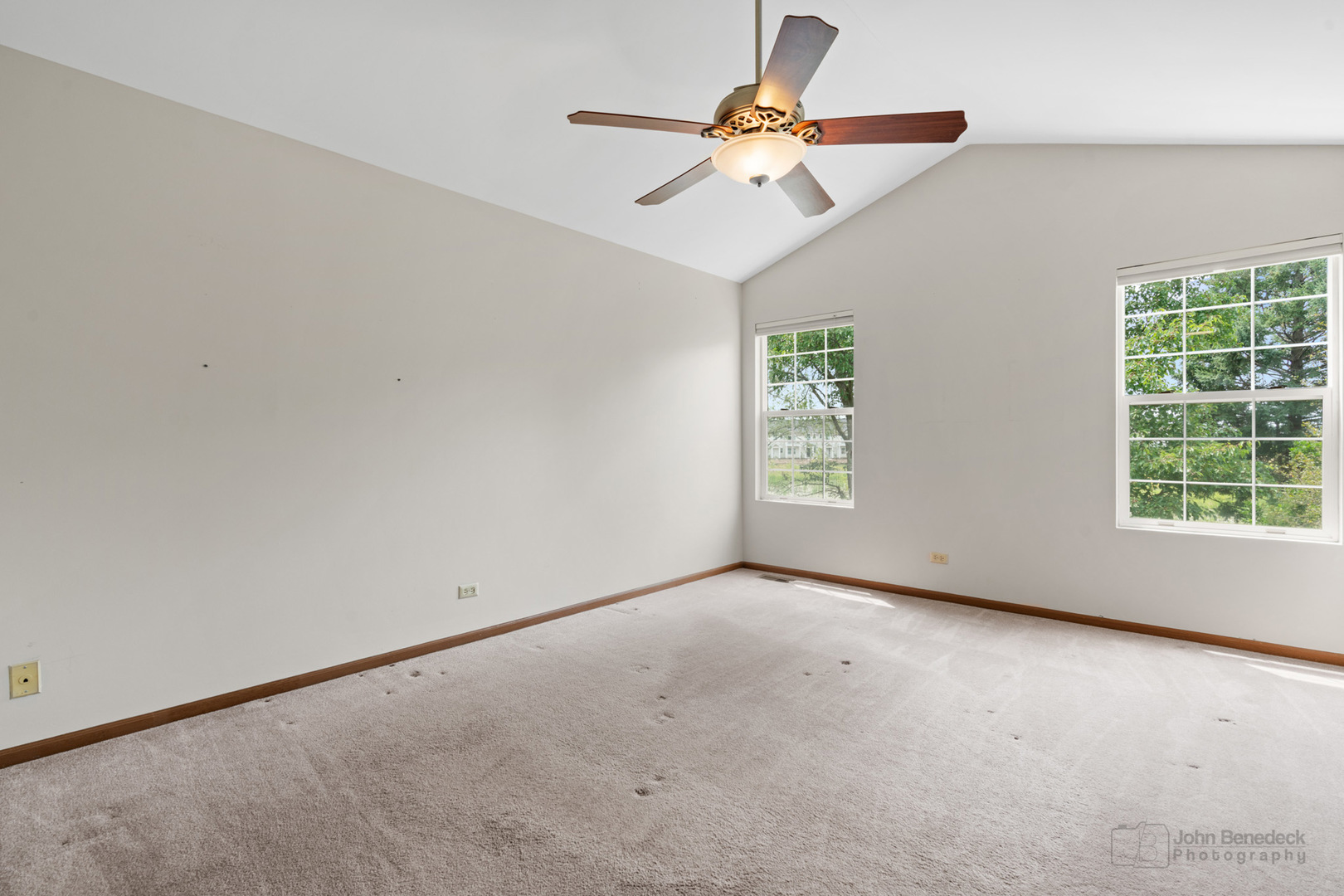 115 Ione Drive, Unit E South Elgin, IL 60177 - Photo 13 of 29 an empty room with windows and fan