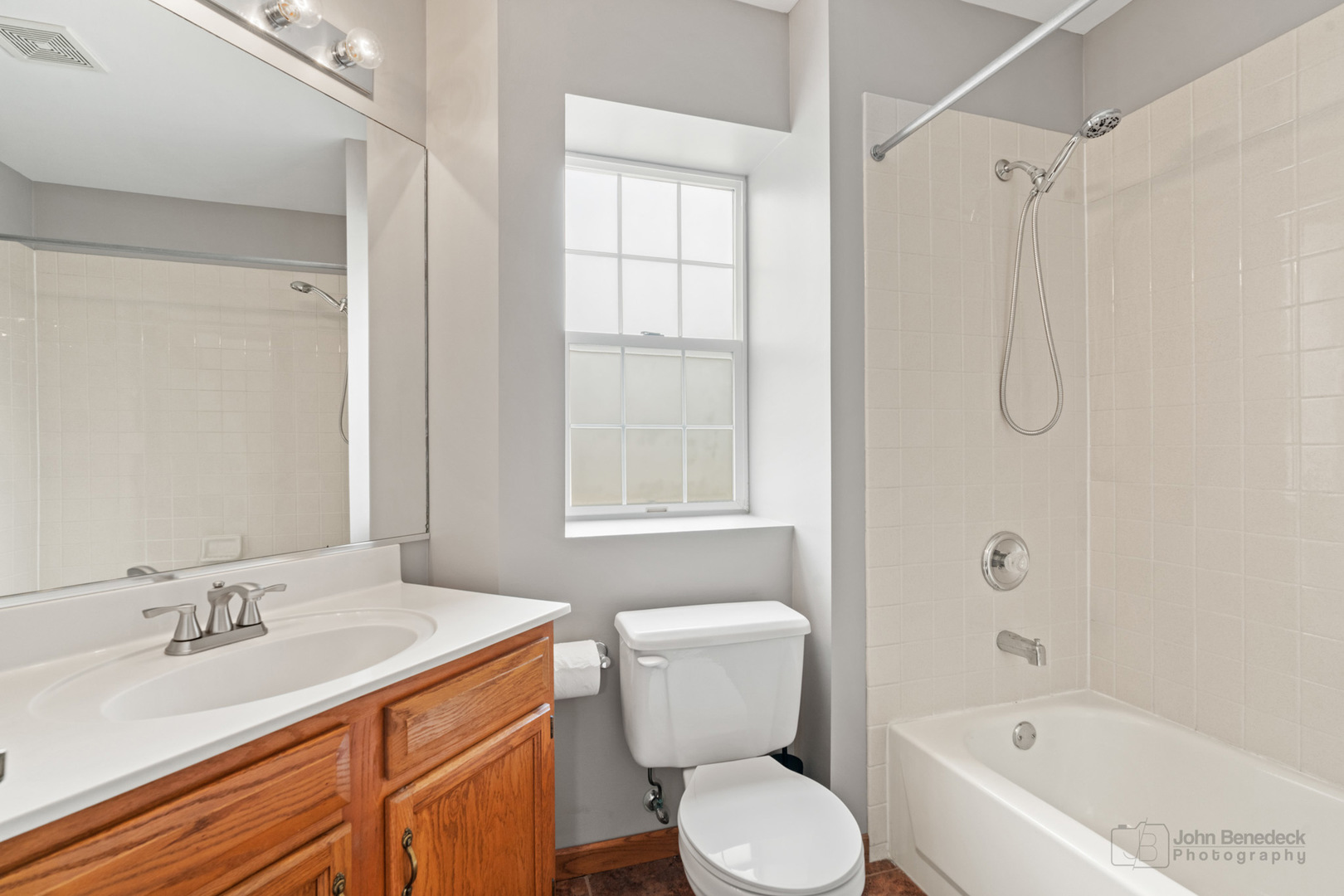 115 Ione Drive, Unit E South Elgin, IL 60177 - Photo 18 of 29 a bathroom with a granite countertop sink toilet and shower