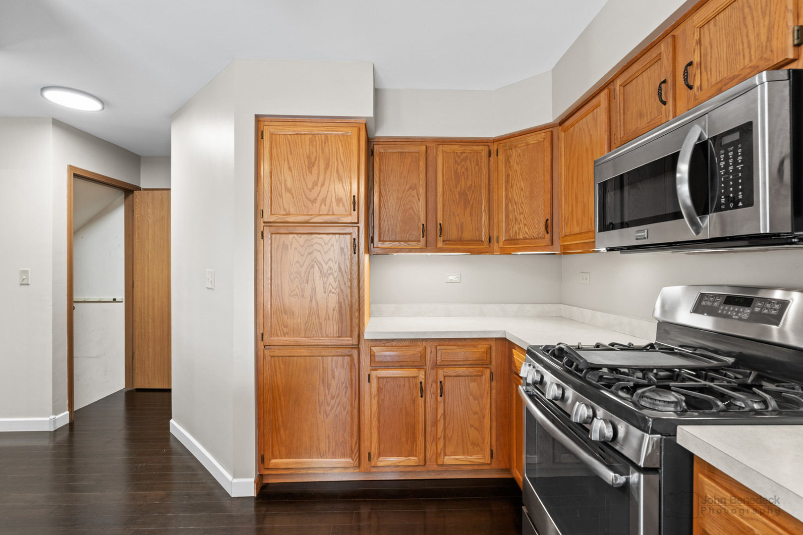115 Ione Drive, Unit E South Elgin, IL 60177 - Photo 7 of 29 a kitchen with stainless steel appliances granite countertop a stove microwave and refrigerator