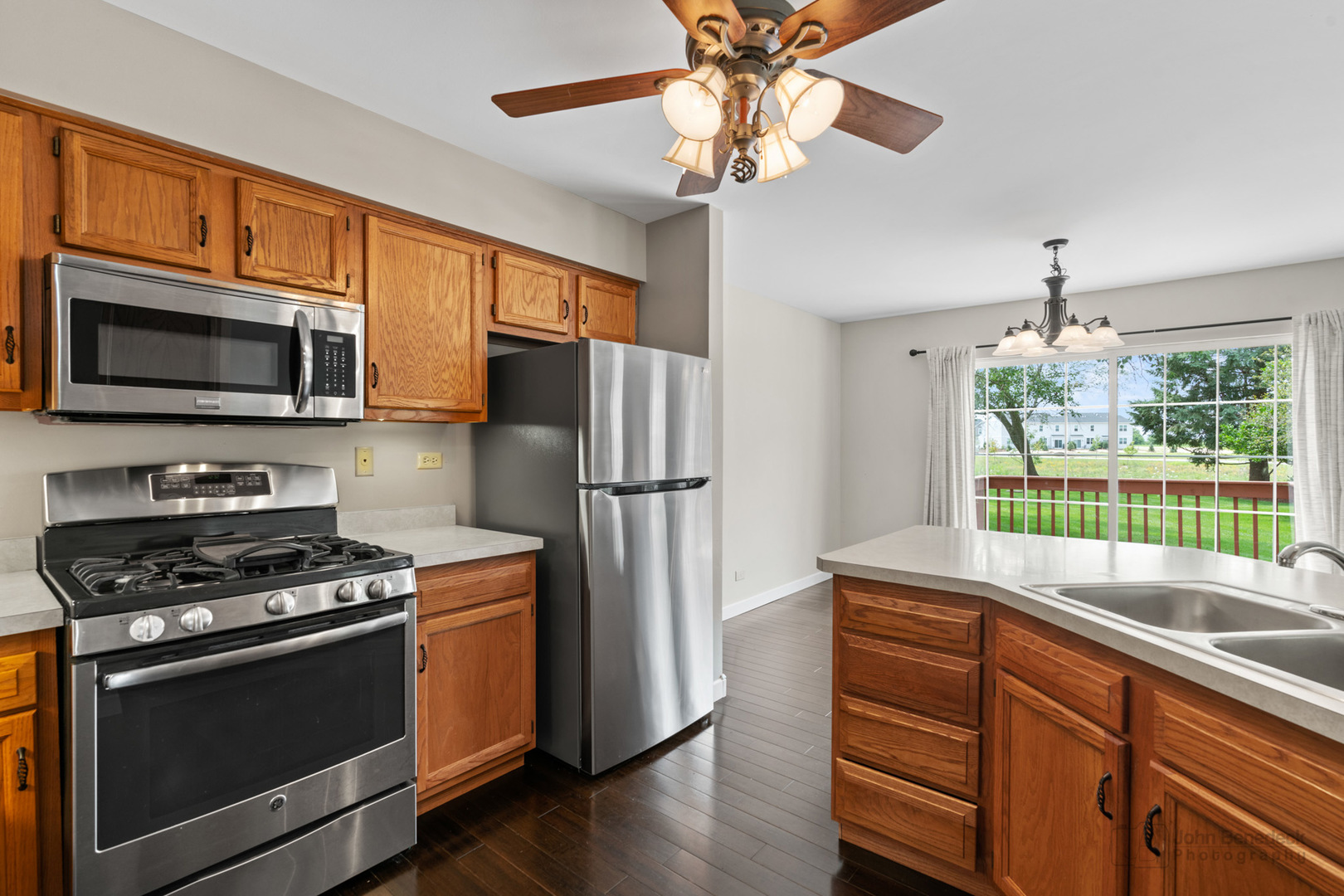 115 Ione Drive, Unit E South Elgin, IL 60177 - Photo 9 of 29 a kitchen with stainless steel appliances a stove microwave and refrigerator