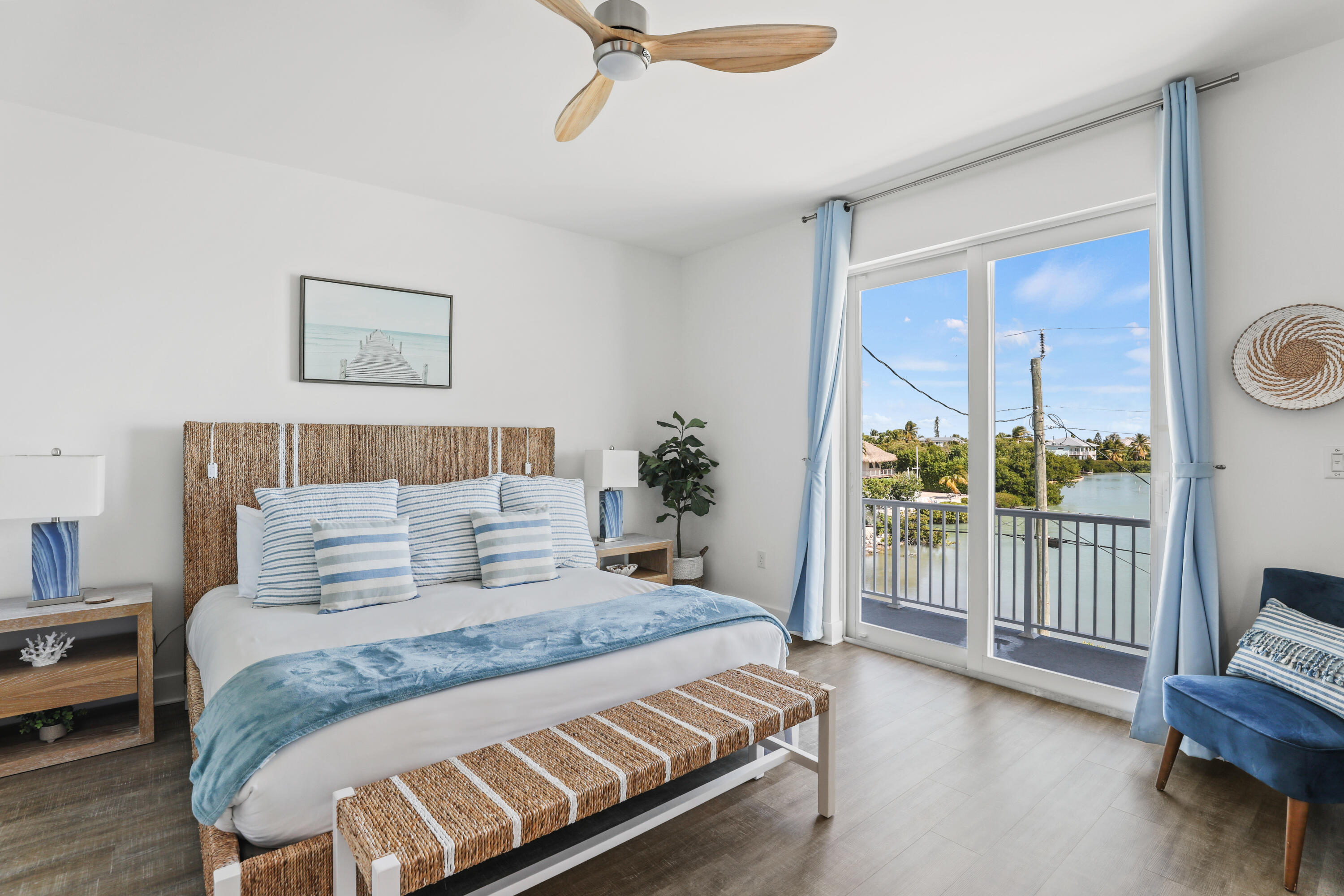 1140 92nd Street Marathon, FL 33050 - Photo 11 of 32 a bedroom with a large bed and a chandelier
