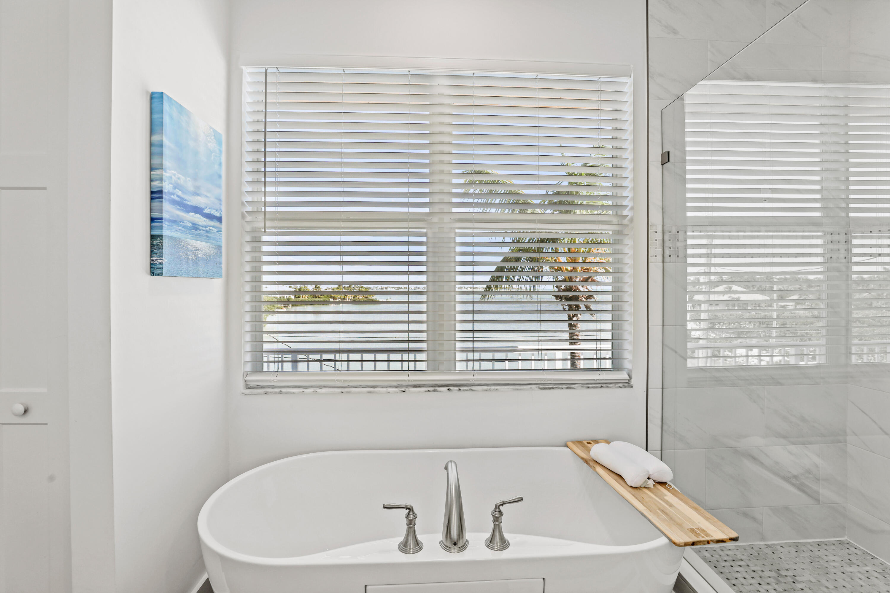 1140 92nd Street Marathon, FL 33050 - Photo 13 of 32 a bath tub sitting in a bathroom next to a window