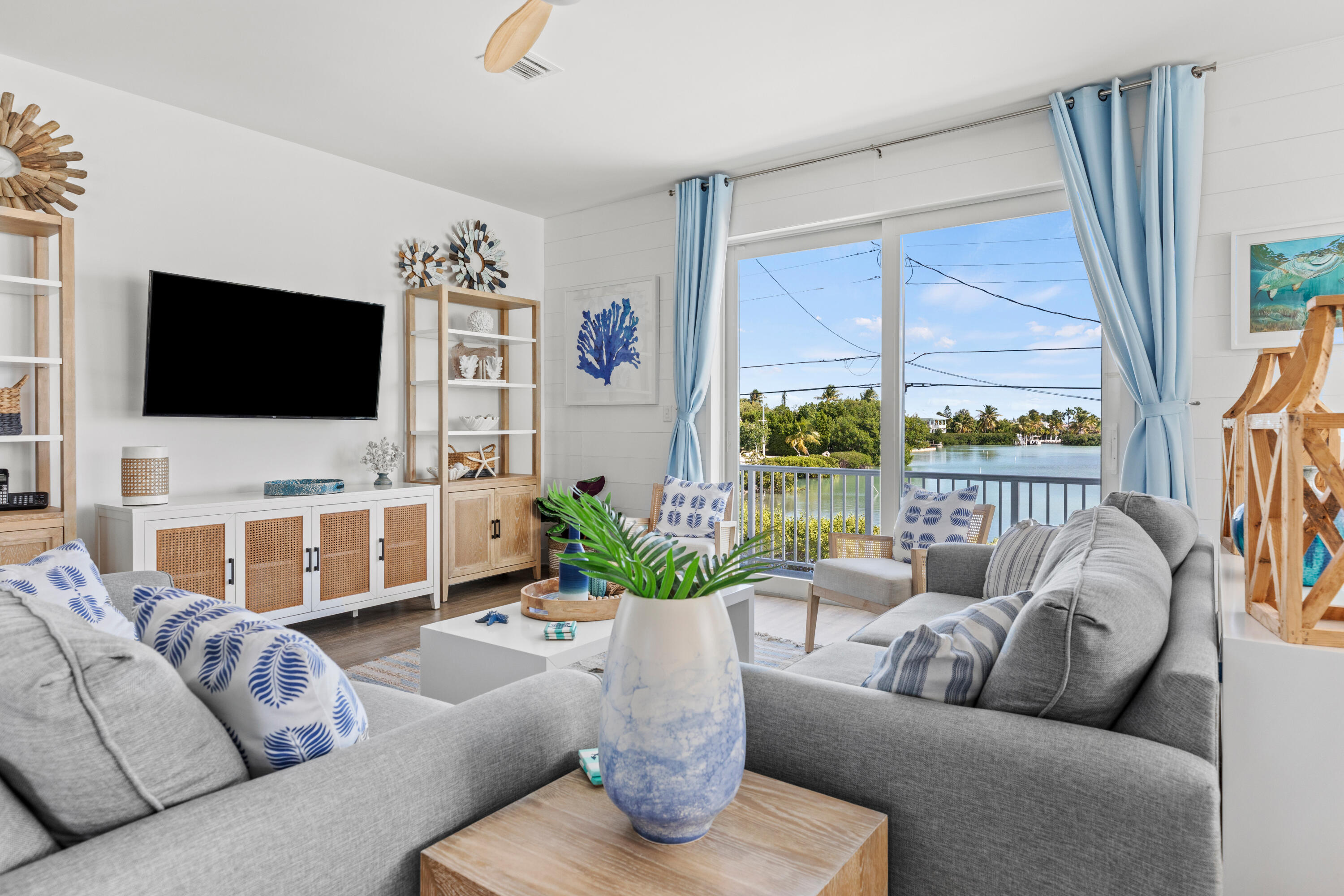 1140 92nd Street Marathon, FL 33050 - Photo 9 of 32 a living room with furniture a flat screen tv and a large window