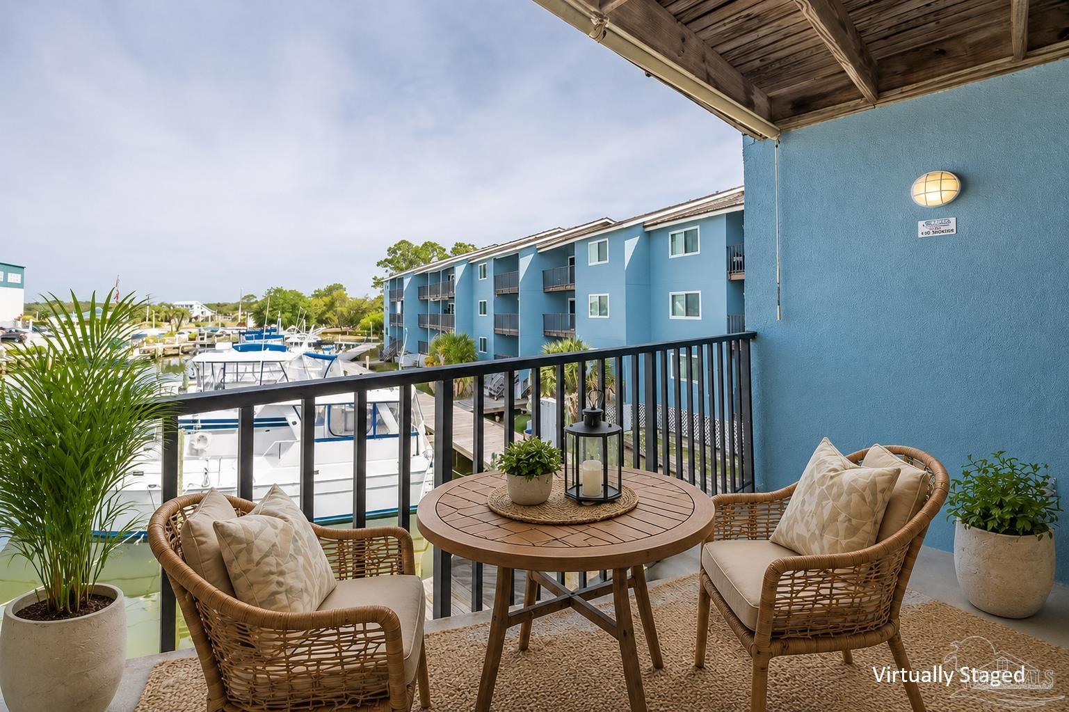 14100 River Road, Unit 228B Pensacola, FL 32507 - Photo 29 of 41 a balcony with table and chairs
