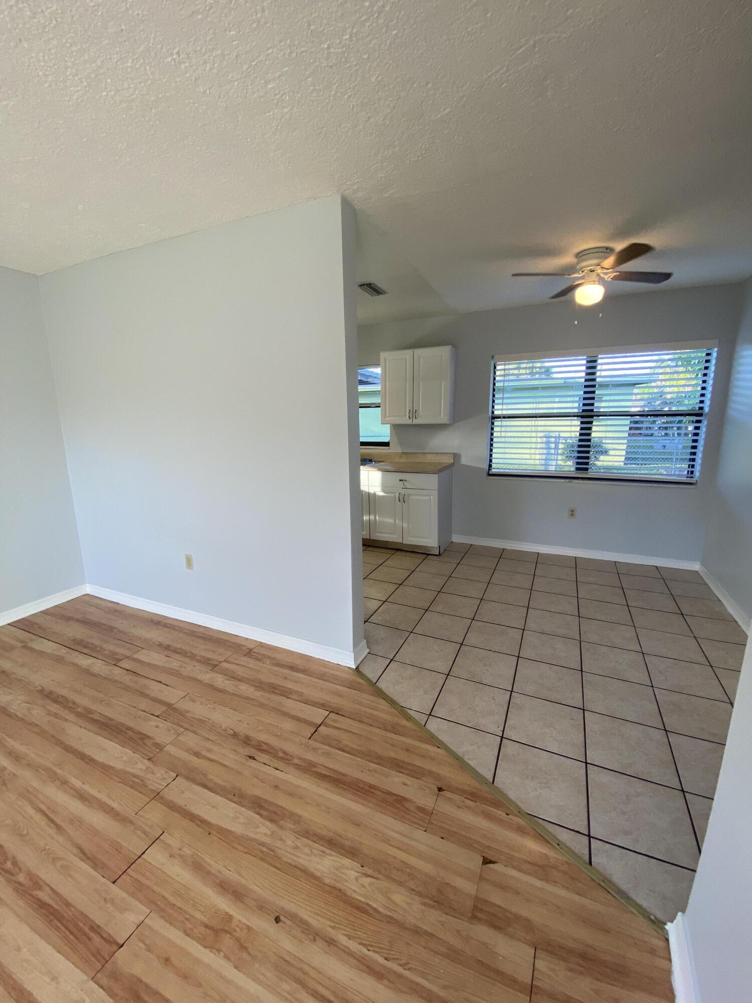118 Explorer Street Cocoa, FL 32922 - Photo 14 of 19 a view of empty room with window and wooden floor