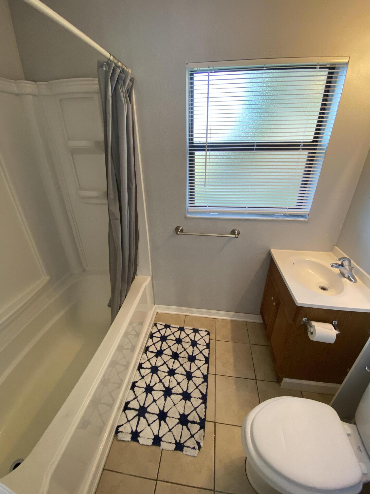118 Explorer Street Cocoa, FL 32922 - Photo 16 of 19 a bathroom with a sink a toilet a window and vanity