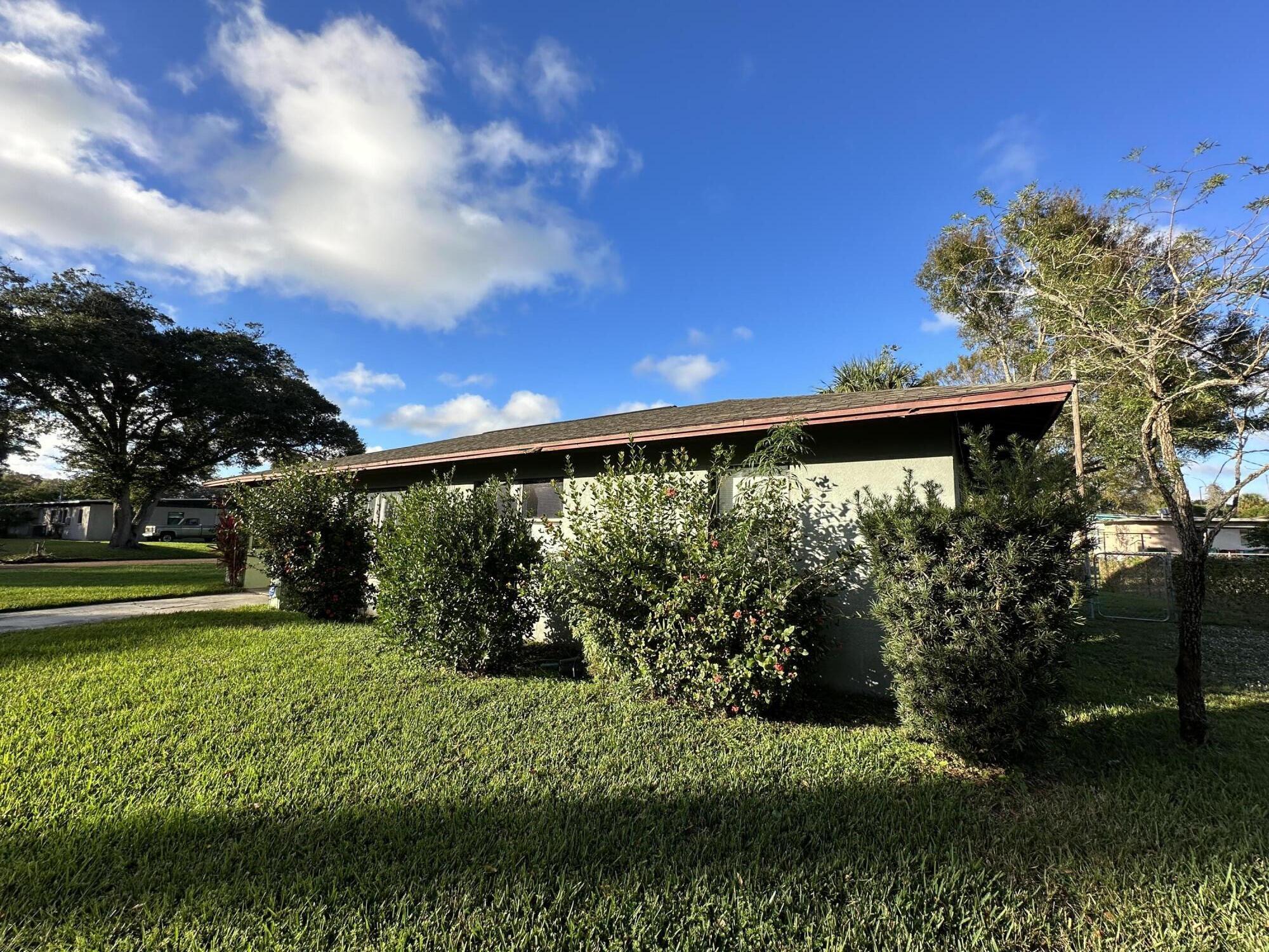 118 Explorer Street Cocoa, FL 32922 - Photo 6 of 19 a view of a big yard with potted plants and large tree