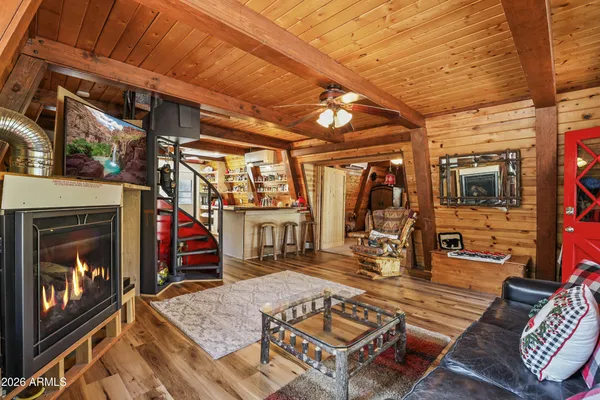 a living room with furniture a fireplace and a window