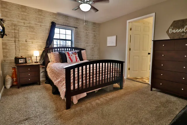 a bedroom with a bed and a dresser