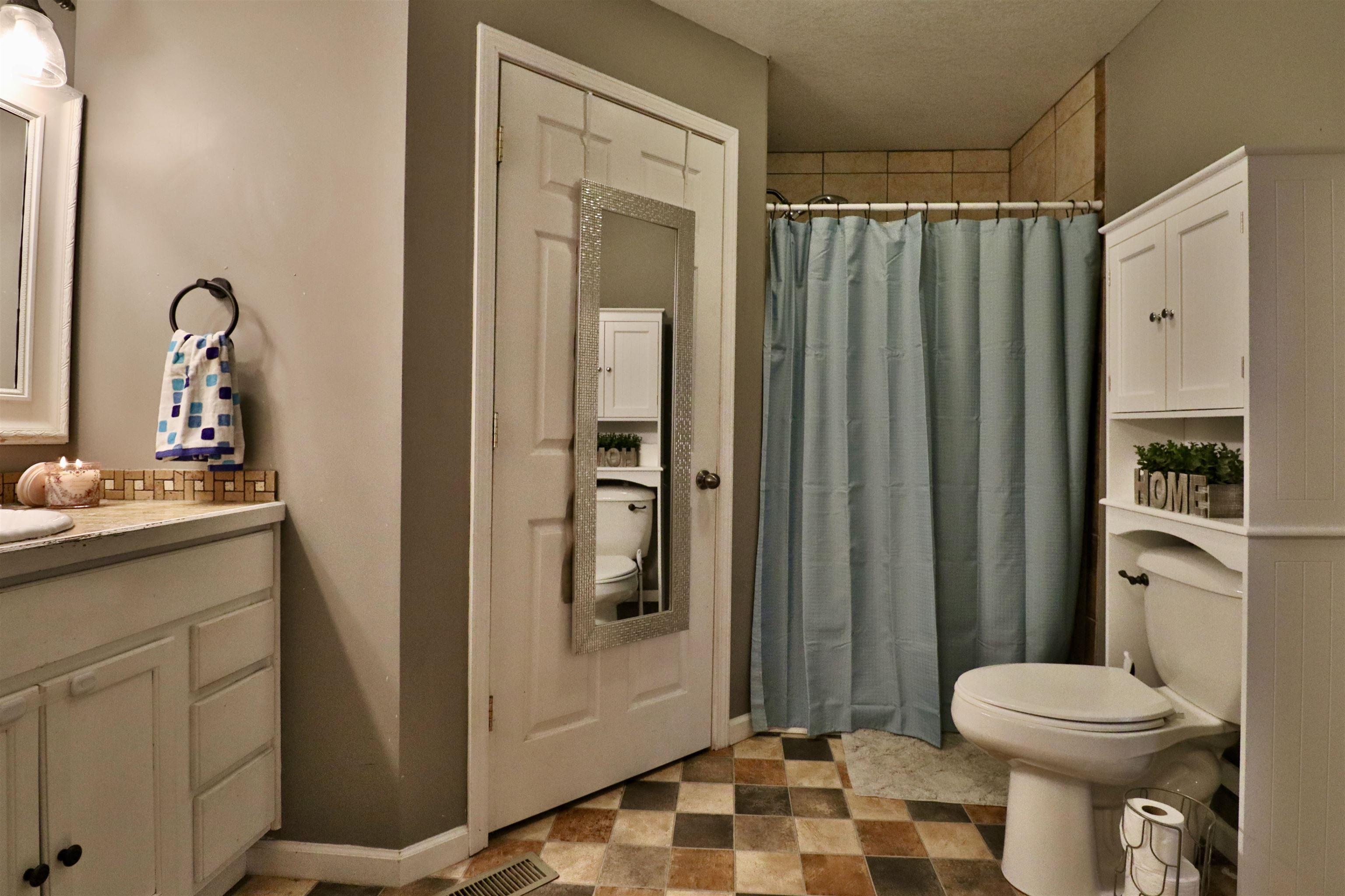 117 Charlie Ennis Road Dyersburg, TN 38024 - Photo 16 of 40 a bathroom with a sink a toilet and shower