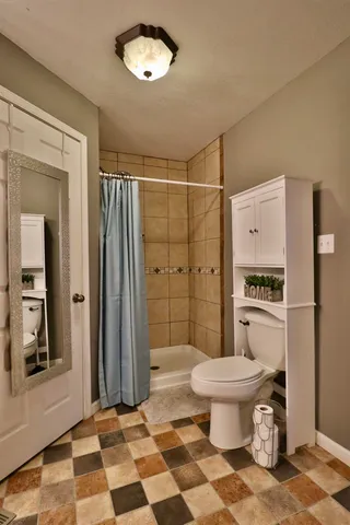 a bathroom with a toilet a sink and a shower
