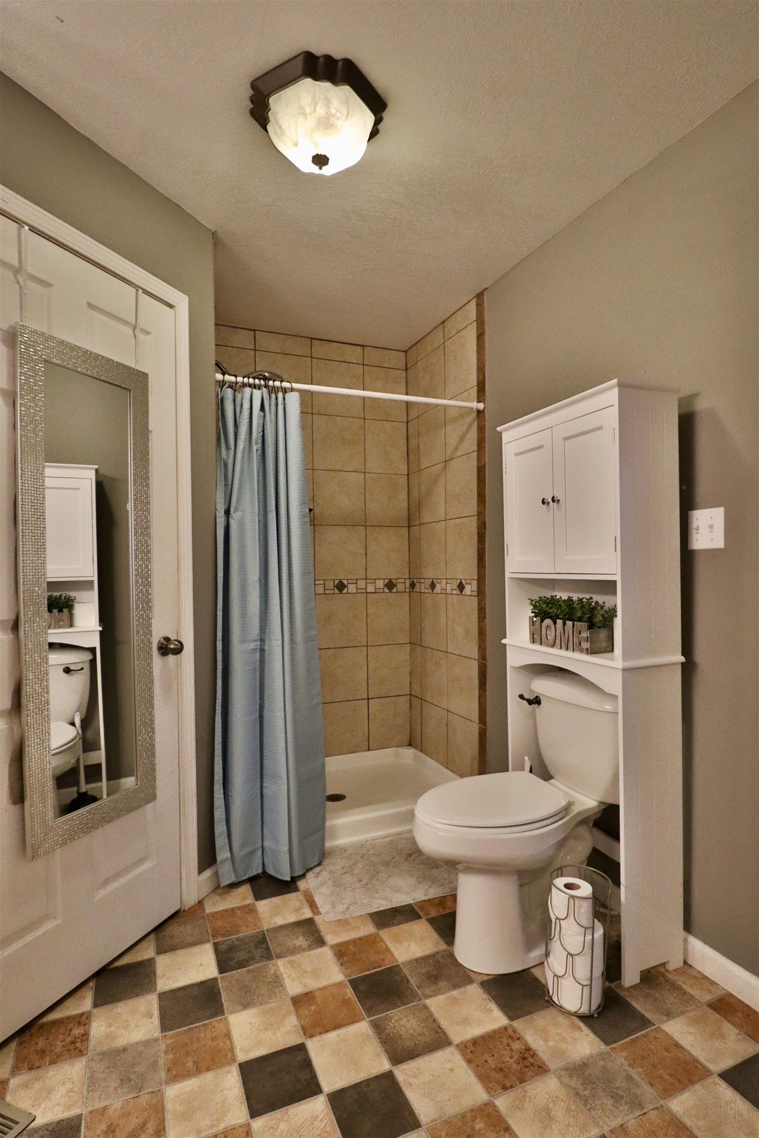 117 Charlie Ennis Road Dyersburg, TN 38024 - Photo 17 of 40 a bathroom with a toilet a sink and a shower