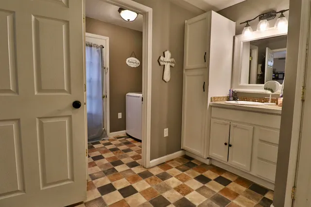 a bathroom with a sink and a mirror