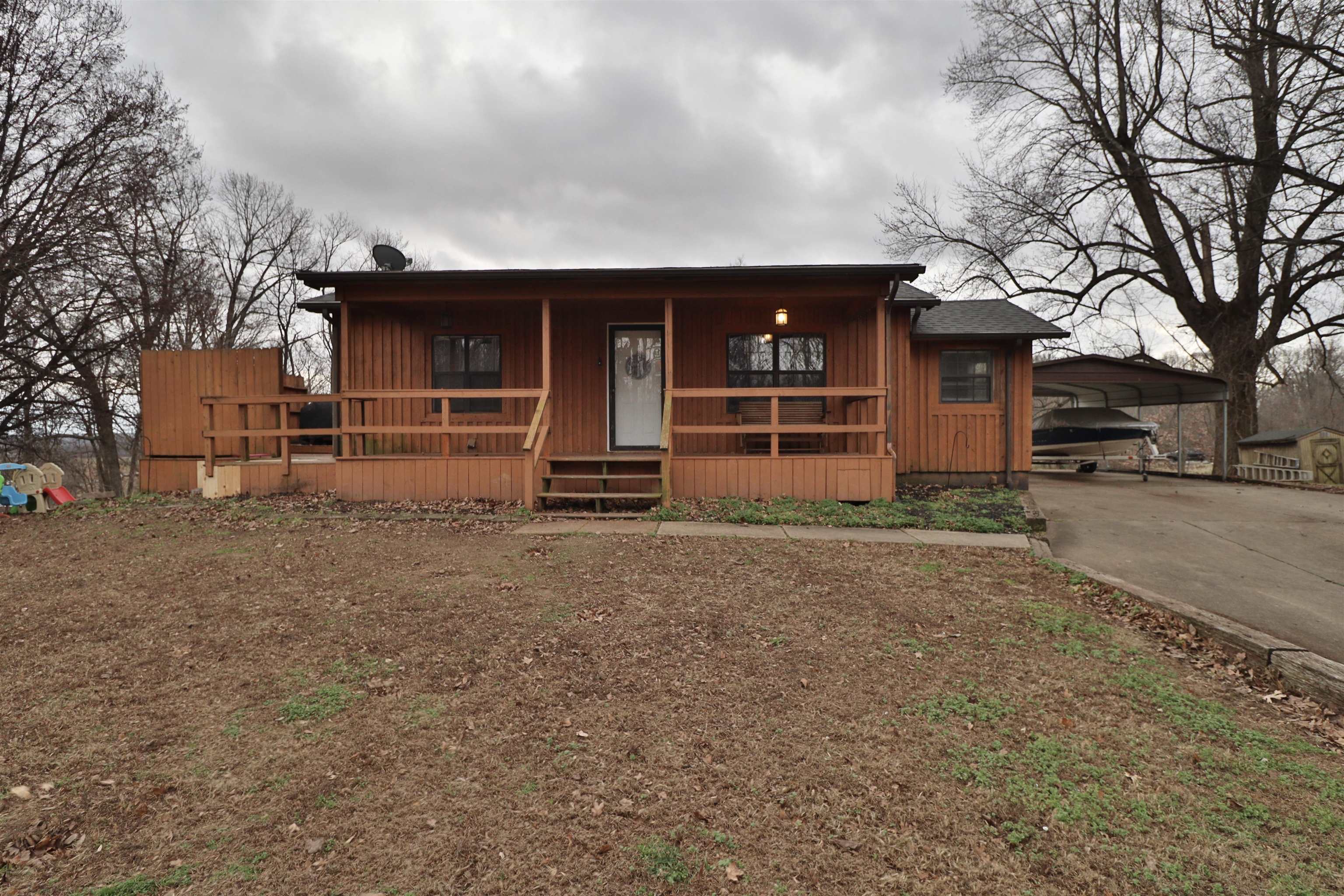 117 Charlie Ennis Road Dyersburg, TN 38024 - Photo 28 of 40 a front view of a house with a yard and garage