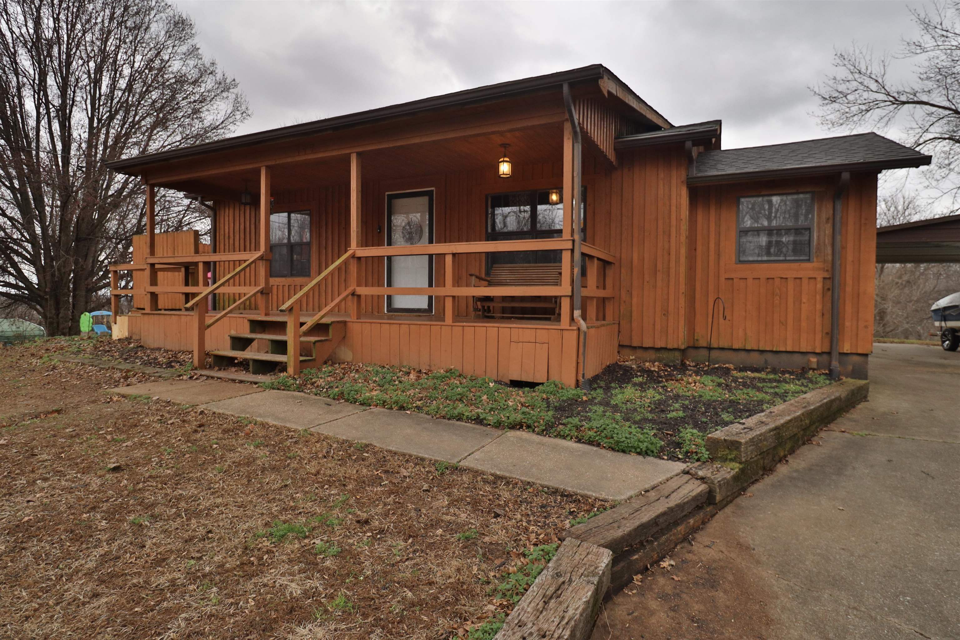 117 Charlie Ennis Road Dyersburg, TN 38024 - Photo 29 of 40 a front view of a house with garden