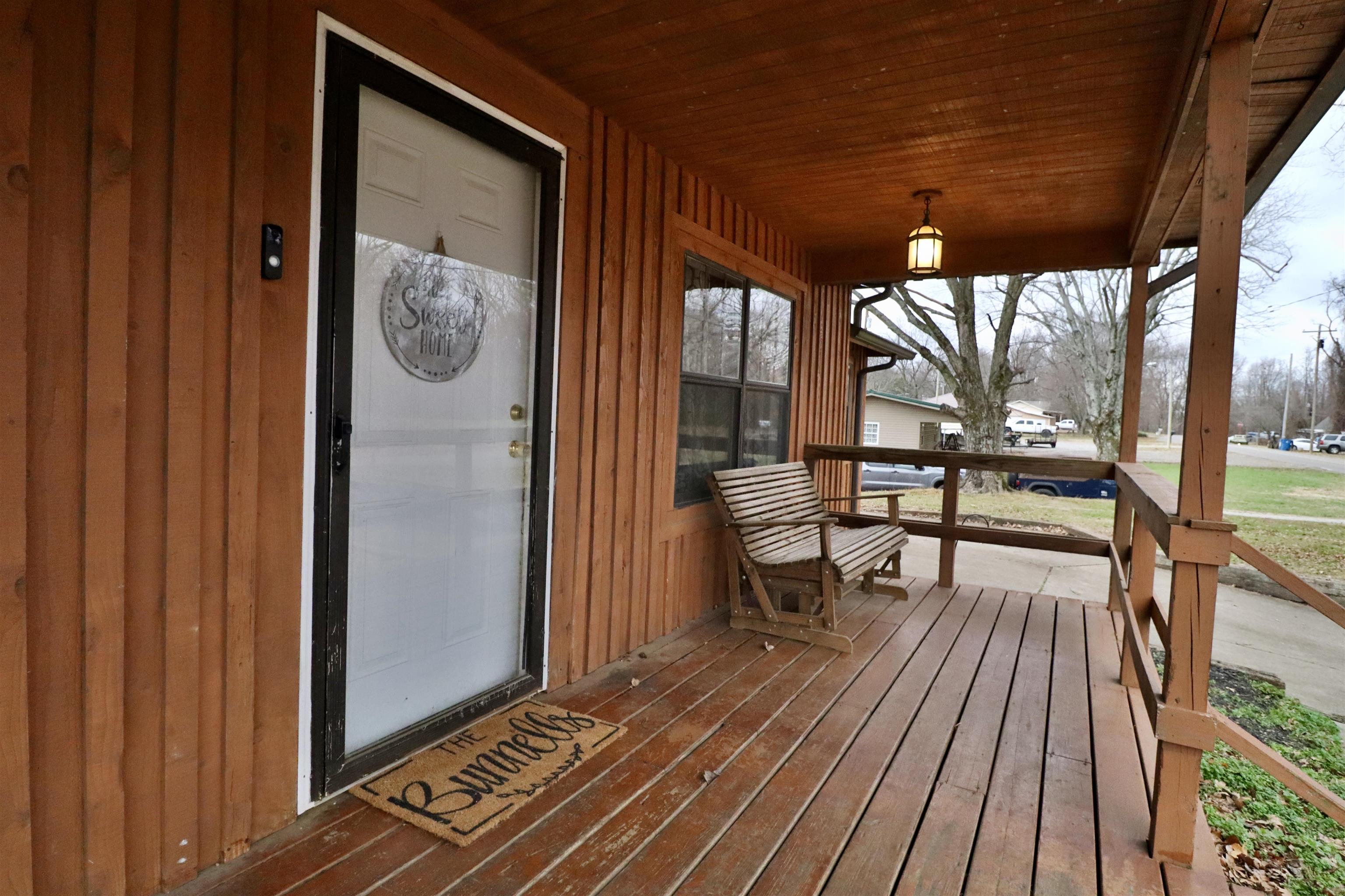 117 Charlie Ennis Road Dyersburg, TN 38024 - Photo 3 of 40 a view of a balcony with chairs and wooden floor