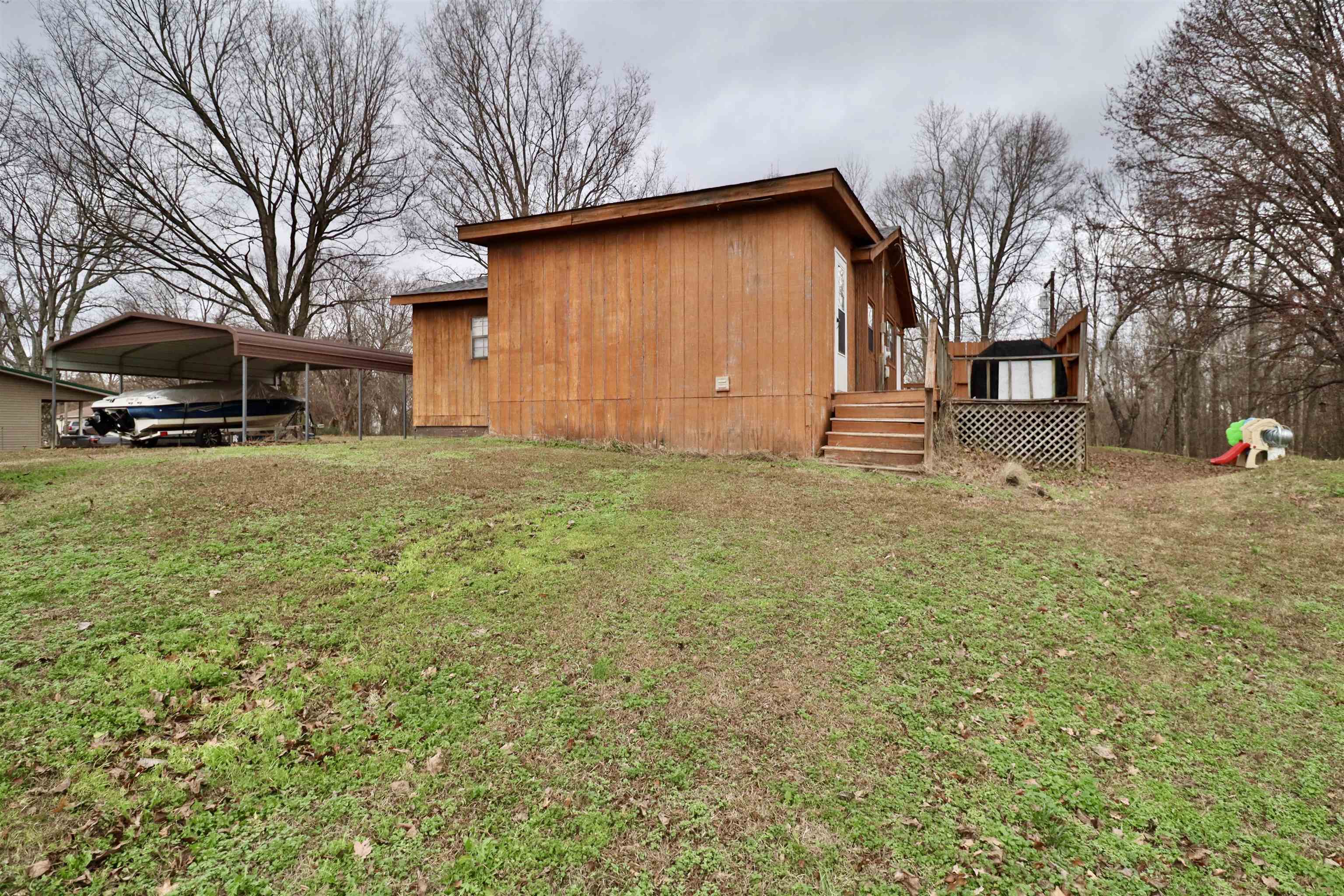 117 Charlie Ennis Road Dyersburg, TN 38024 - Photo 31 of 40 a view of a yard with a house and a tree