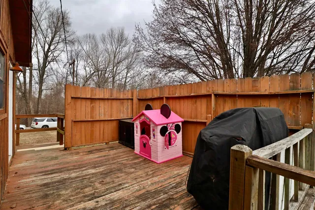 a street view with wooden fence and trees
