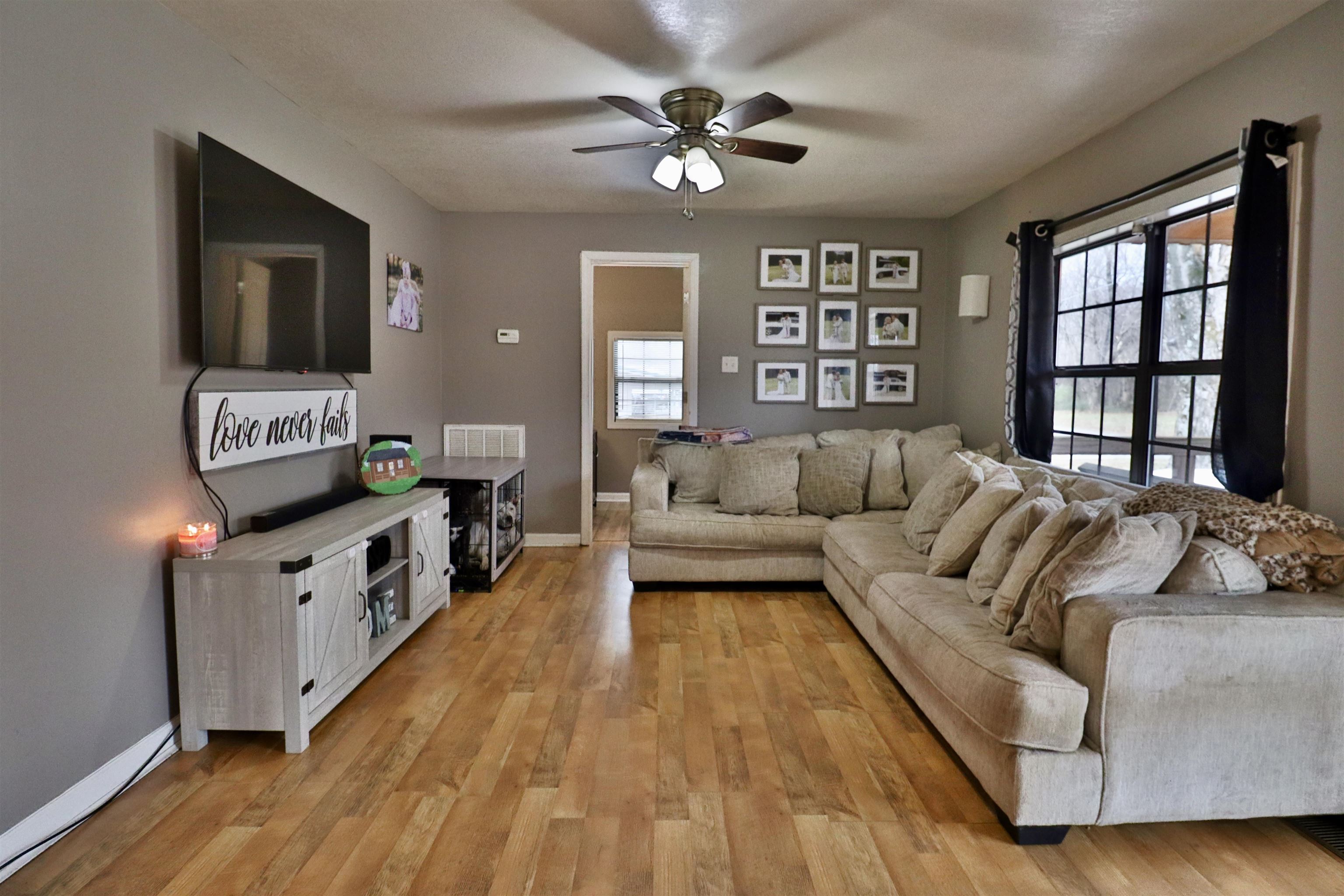 117 Charlie Ennis Road Dyersburg, TN 38024 - Photo 5 of 40 a living room with furniture and a flat screen tv