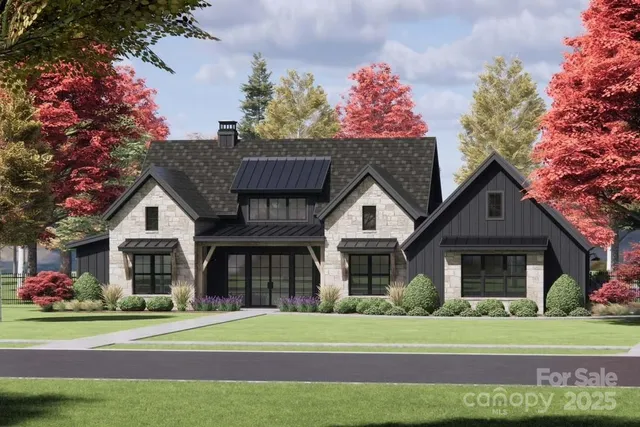 a front view of a house with a garden and trees