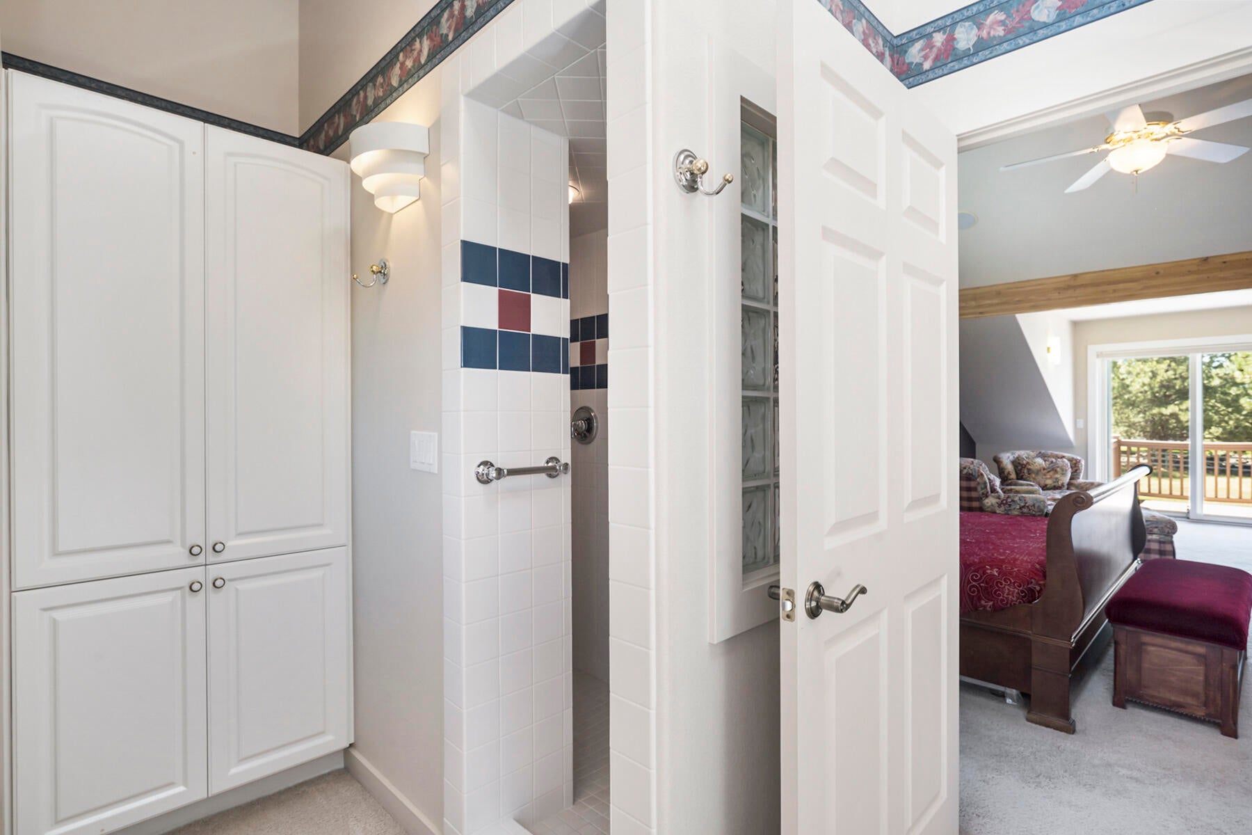 60696 Tekampe Road Bend, OR 97702 - Photo 35 of 61 Tile walk-in shower, built in cabinets with laundry chute, upper level primary suite