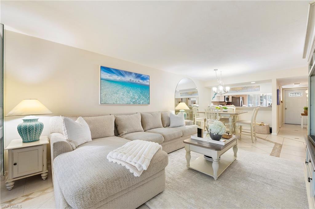 4085 Northlight Drive, Unit 5607 Naples, FL 34112 - Photo 24 of 49 a living room with furniture and a lamp