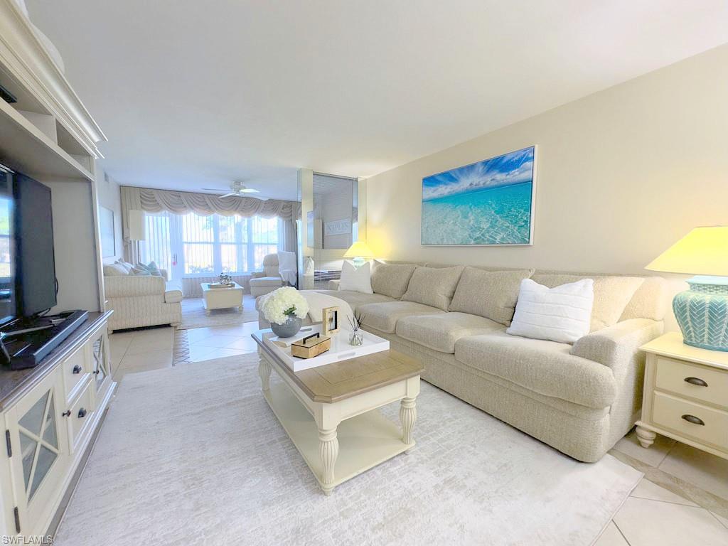 4085 Northlight Drive, Unit 5607 Naples, FL 34112 - Photo 26 of 49 a living room with furniture and a flat screen tv