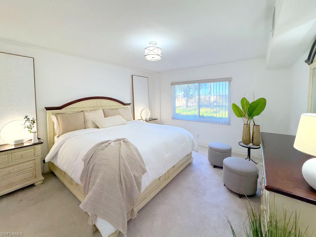 4085 Northlight Drive, Unit 5607 Naples, FL 34112 - Photo 27 of 49 a bedroom with a bed and a couch