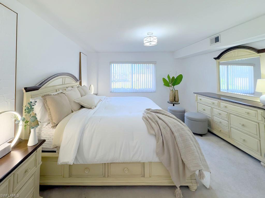 4085 Northlight Drive, Unit 5607 Naples, FL 34112 - Photo 28 of 49 a bedroom with a bed a dresser and potted plants
