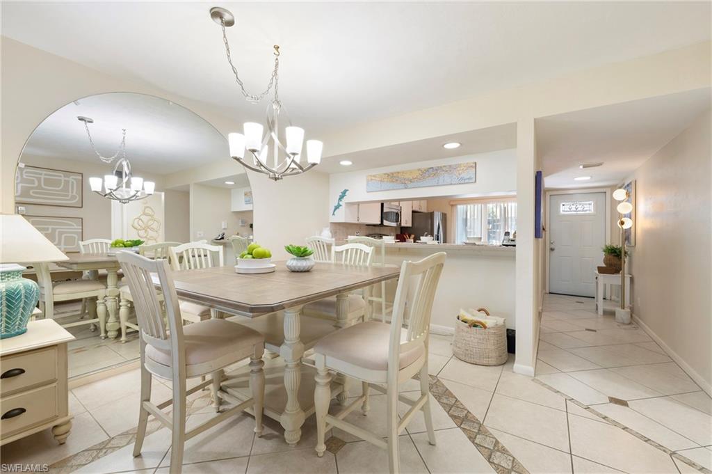 4085 Northlight Drive, Unit 5607 Naples, FL 34112 - Photo 31 of 49 a view of a dining room with furniture and chandelier