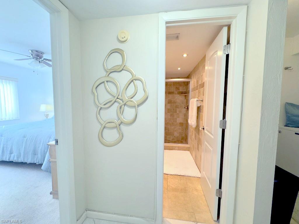 4085 Northlight Drive, Unit 5607 Naples, FL 34112 - Photo 32 of 49 a bathroom with a glass shower door