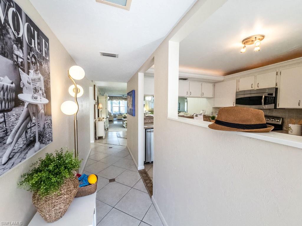 4085 Northlight Drive, Unit 5607 Naples, FL 34112 - Photo 7 of 49 a kitchen with stainless steel appliances a refrigerator and a sink