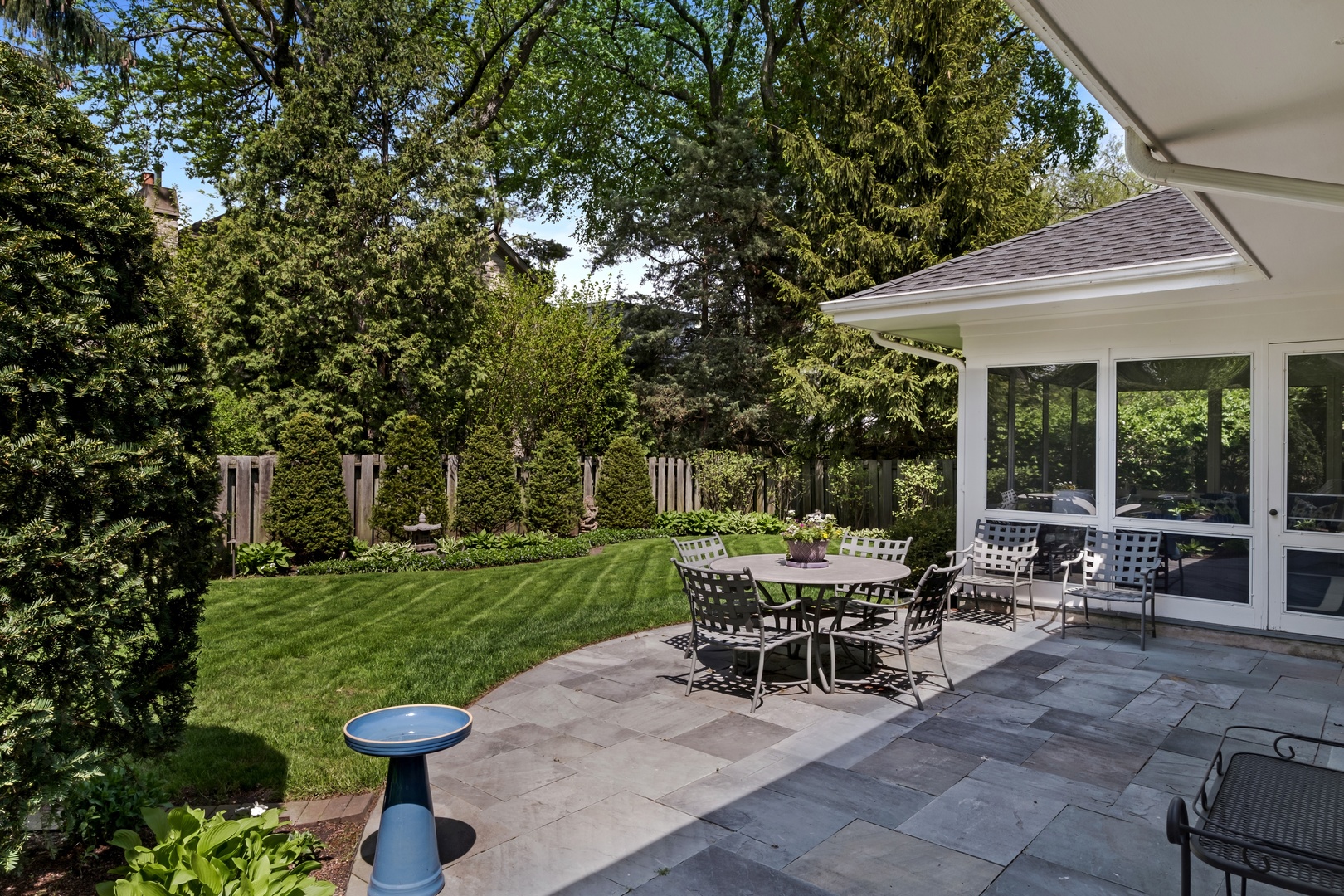1029 Miami Road Wilmette, IL 60091 - Photo 22 of 28 a view of a patio with table and chairs potted plants and large tree