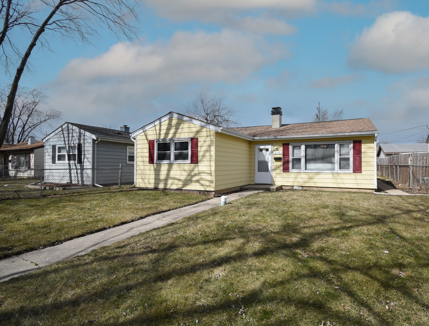 2106 20th Street Zion, IL 60099 - Photo 1 of 22 a front view of a house with a garden