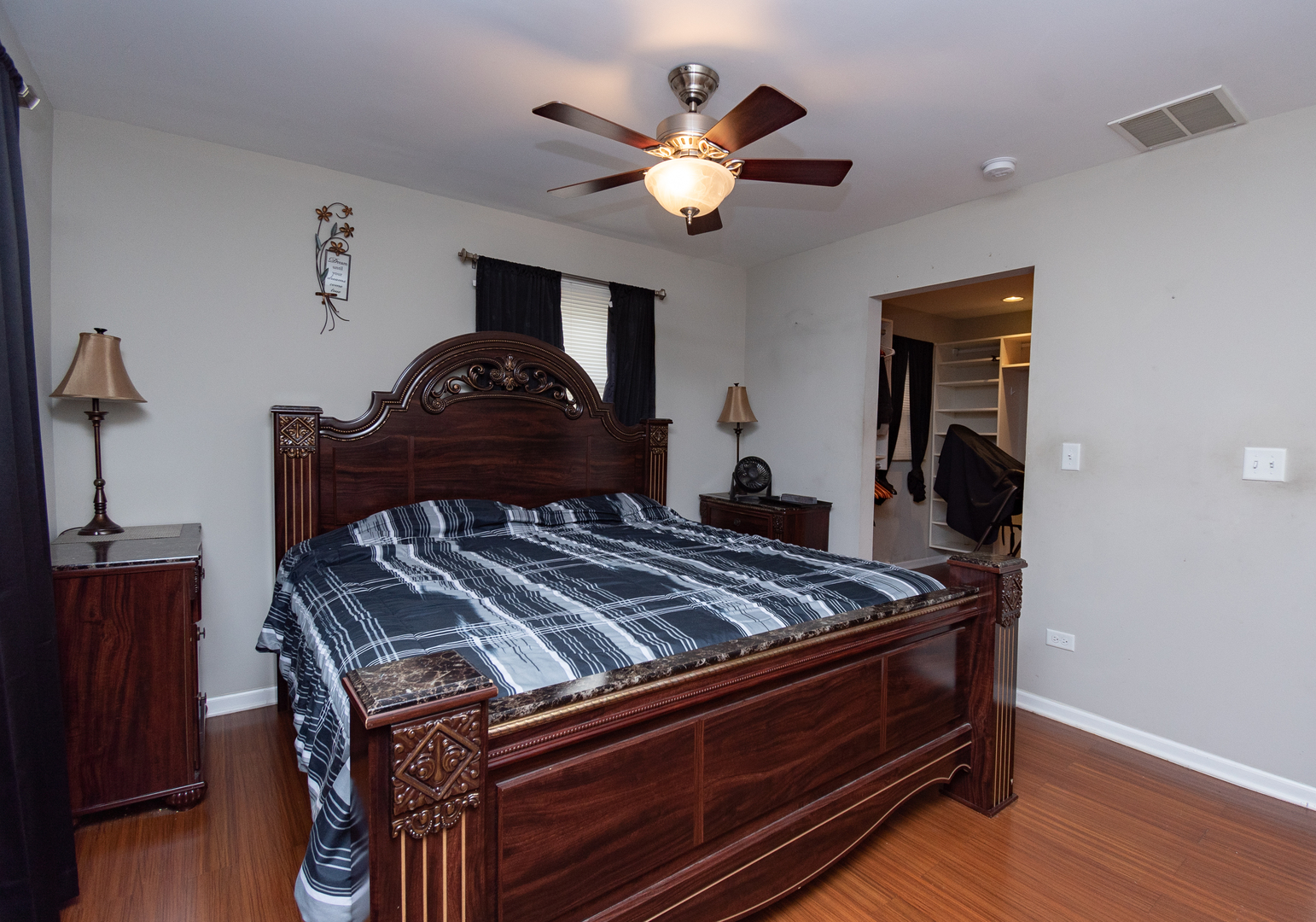 2106 20th Street Zion, IL 60099 - Photo 12 of 22 a bed sitting in a bedroom next to a window