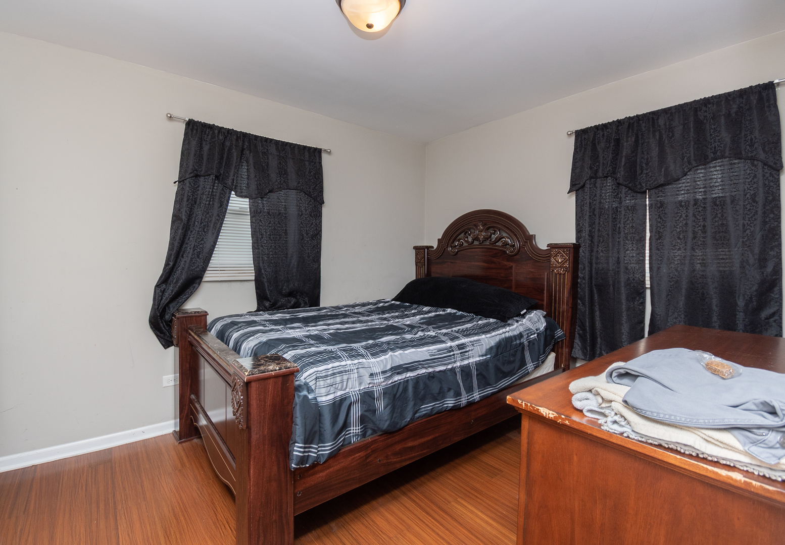 2106 20th Street Zion, IL 60099 - Photo 14 of 22 a bedroom with a bed and a dresser