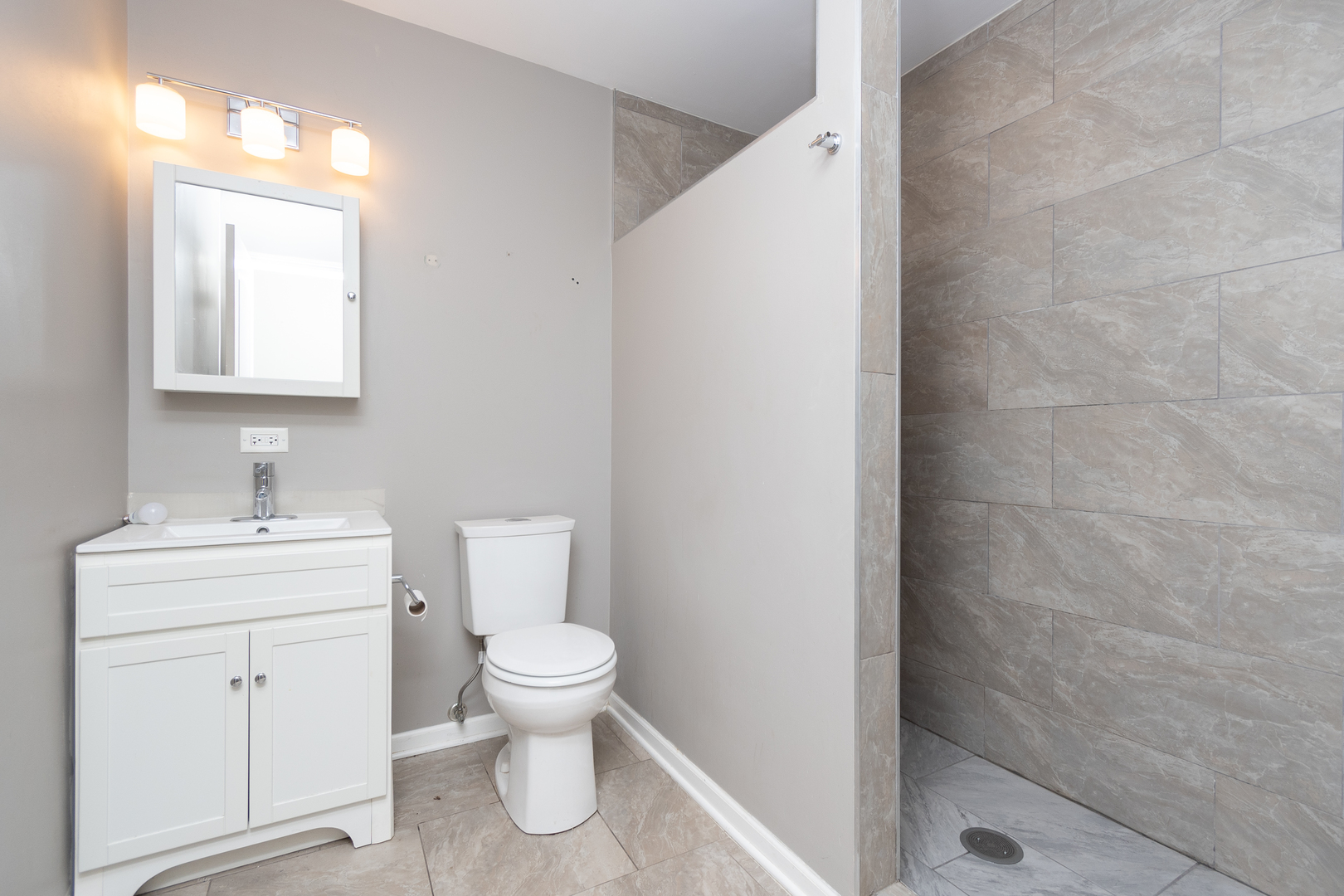 2106 20th Street Zion, IL 60099 - Photo 15 of 22 a bathroom with a toilet a sink and mirror